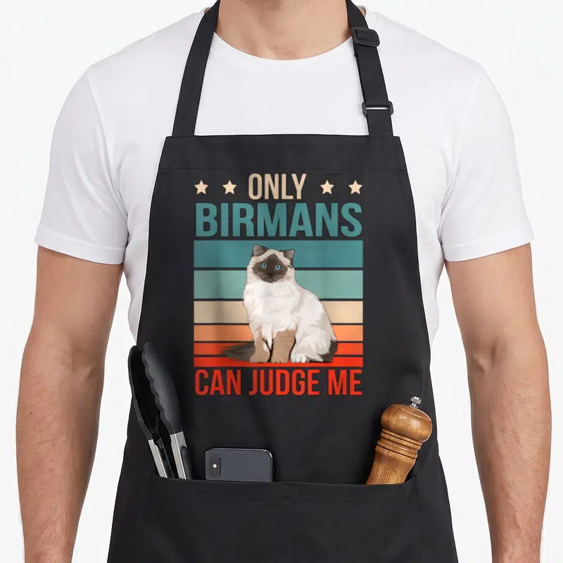 Tablier de cuisine noir avec illustration d'un chat birman et texte Only Birmans Can Judge Me en lettres colorées.