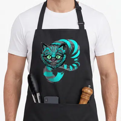 Tablier de cuisine noir avec tête de chat aux yeux verts et sourire large style Cheshire