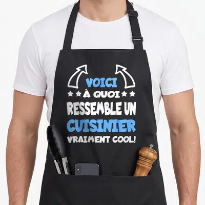 Tablier de cuisine noir avec le texte voici à quoi ressemble un cuisinier vraiment cool en blanc et bleu.