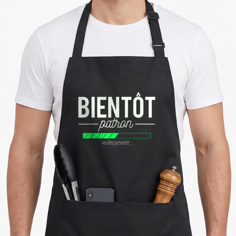 Tablier de cuisine noir avec inscription Bientôt patron et barre de progression verte.