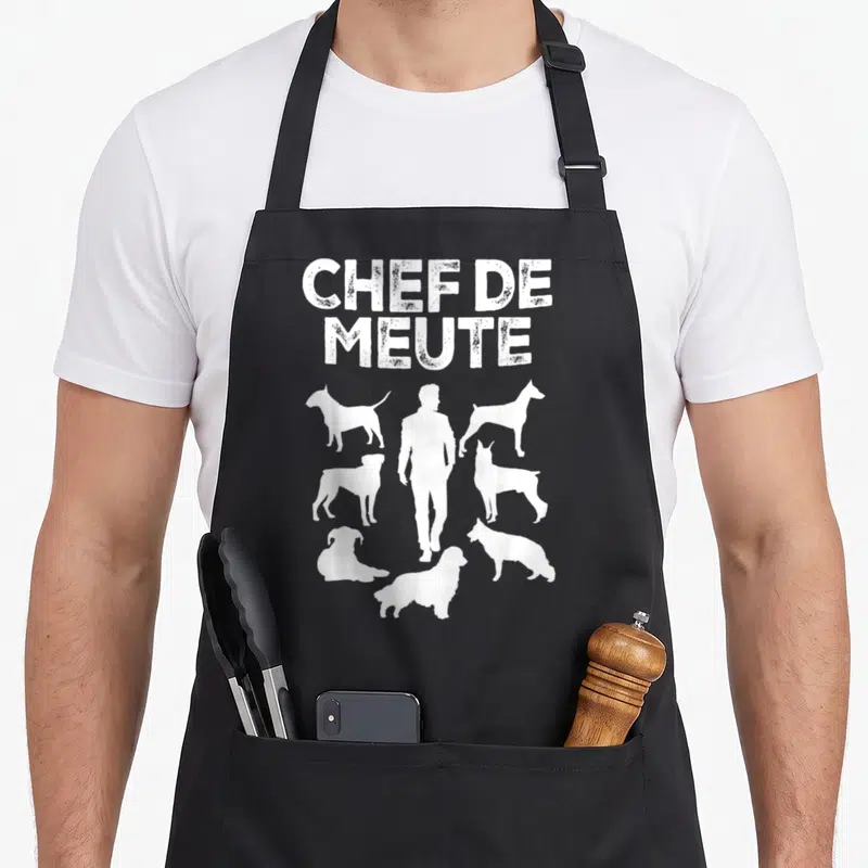 Tablier de cuisine noir avec inscription Chef de meute et silhouettes blanches de chiens et d'un homme debout.