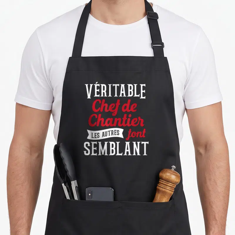 Tablier de cuisine noir avec l'inscription blanche et rouge Véritable Chef de Chantier les autres font semblant.