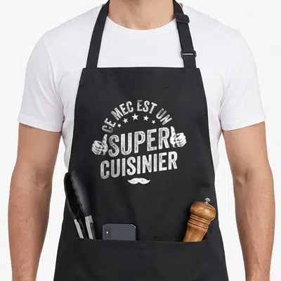 Tablier de cuisine noir avec inscription Ce mec est un super cuisinier, deux mains et une moustache blanche.