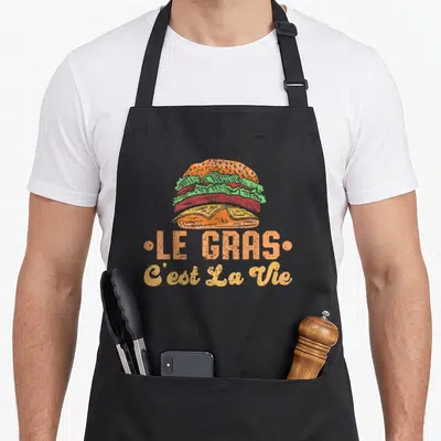 Tablier de cuisine noir avec illustration de burger colorée et texte Le Gras C'est La Vie en orange et jaune.