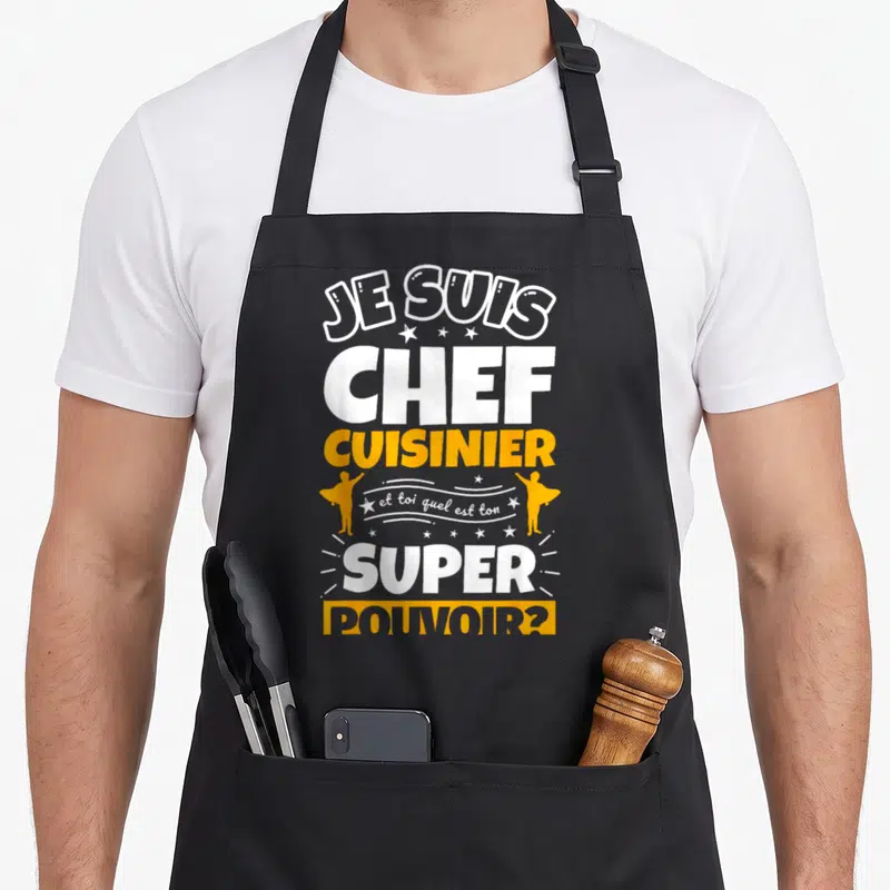 Tablier de cuisine noir avec inscription je suis chef cuisinier et toi quel est ton super pouvoir en blanc et orange.
