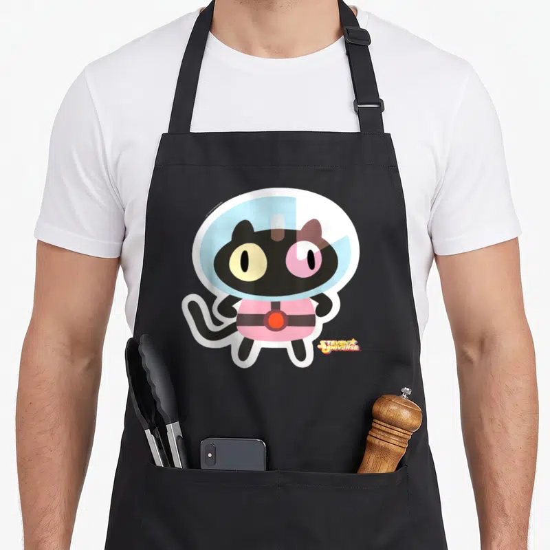 Tablier de cuisine noir avec illustration du Chat Biscuit en combinaison spatiale rose et casque bleu, logo Steven Universe en bas à droite.