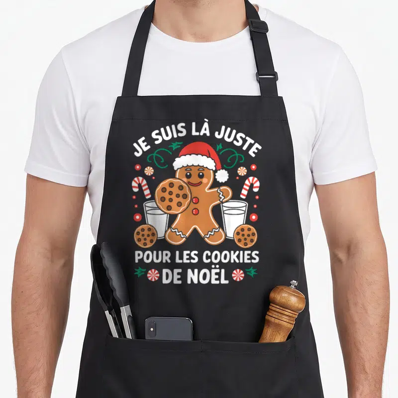 Tablier de cuisine noir avec un bonhomme de Noël tenant un cookie et deux verres de lait.