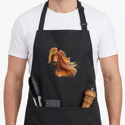 Tablier de cuisine noir avec une illustration artistique d'une tête de pony aux longs cheveux aux teintes dorées et roses.