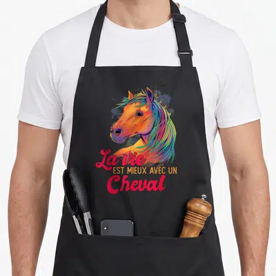 Tablier de cuisine noir avec tête de cheval colorée et texte La vie est mieux avec un Cheval en lettres roses et jaunes.