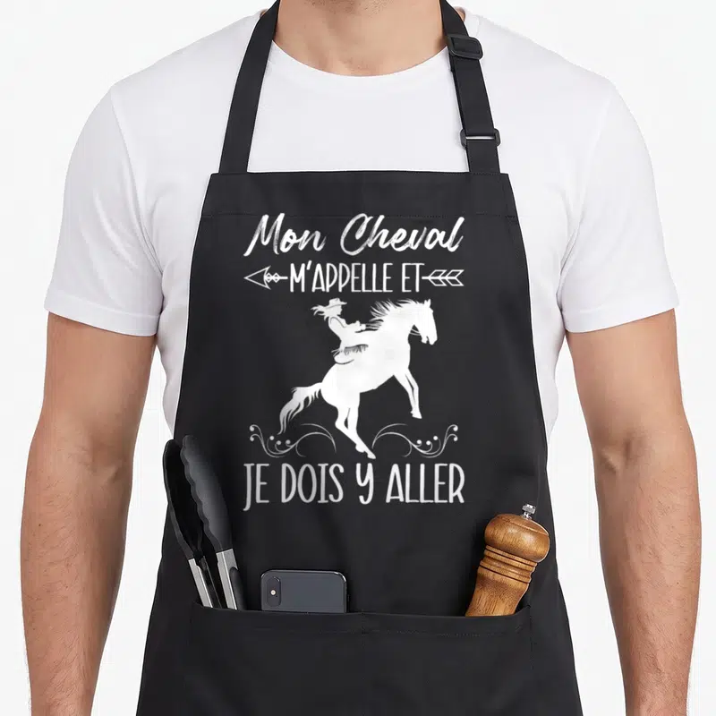 Tablier de cuisine noir avec une silhouette blanche de cavalière, des flèches et le texte Mon Cheval M'Appelle et Je Dois Y Aller.