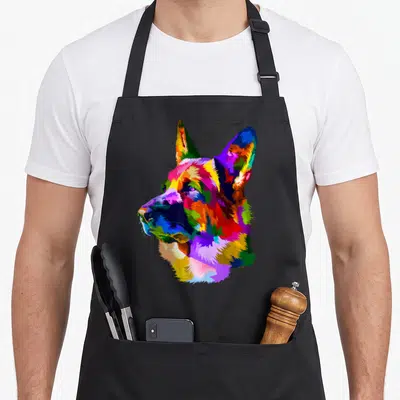 Tablier de cuisine noir avec portrait artistique d'un berger allemand aux multiples couleurs vives.