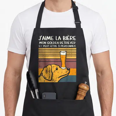Tablier de cuisine noir avec illustration d'un Golden Retriever tenant une bière sur le nez et texte humoristique en haut.
