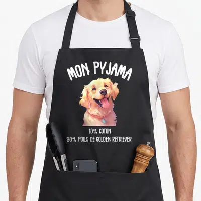 Tablier de cuisine noir avec illustration d'un Golden Retriever souriant et texte humoristique en blanc.