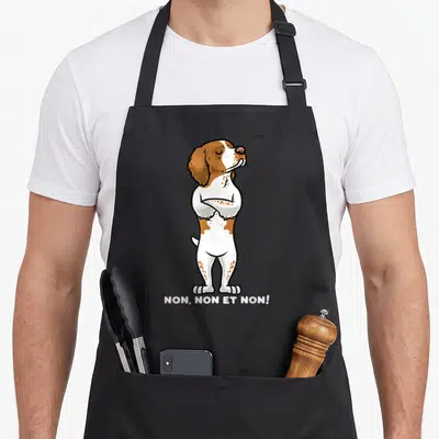 Tablier de cuisine noir avec illustration d'un chien Épagneul breton aux bras croisés et texte NON, NON ET NON