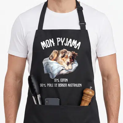 Tablier de cuisine noir avec illustration d'un Berger australien sur une couverture bleue et texte blanc humoristique.