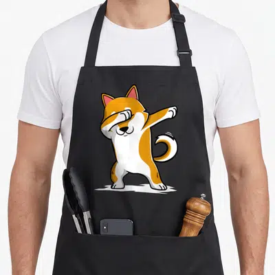 Tablier de cuisine noir avec illustration d'un Shiba Inu orange et blanc effectuant une pose de danse dab.