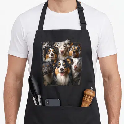Tablier de cuisine noir avec illustration groupée de sept chiens Mini Berger australien aux expressions expressives.