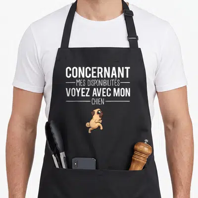 Tablier de cuisine noir avec une illustration de pug et le texte blanc concernant mes disponibilités voyez avec mon chien.
