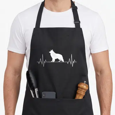 Tablier de cuisine noir avec silhouette blanche de chien et ligne de rythme cardiaque traversant le motif central.
