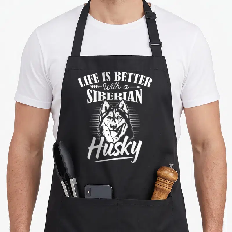 Tablier de cuisine noir avec illustration d'un husky sibérien et le texte Life is Better with a Siberian Husky en blanc.