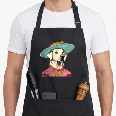 Tablier de cuisine noir avec illustration d'un Labrador Retriever vêtu d'une tenue victorienne rose et turquoise.