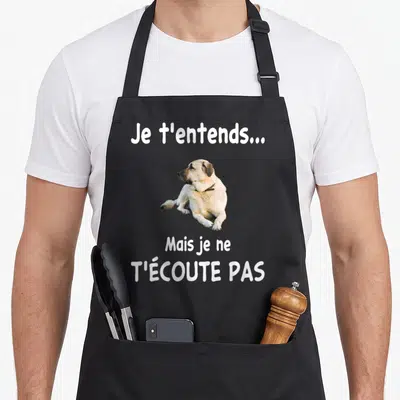Tablier de cuisine noir avec un Berger Kangal et le texte humoristique Je t'entends mais je ne t'écoute pas imprimé en blanc.