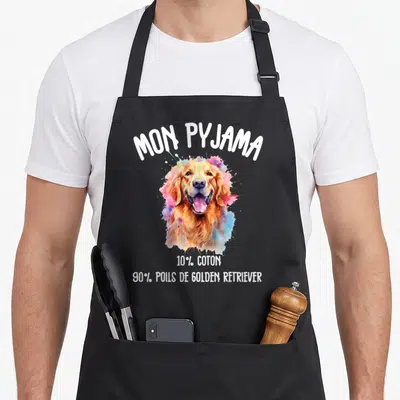 Tablier de cuisine noir avec illustration colorée d'un Golden Retriever et texte blanc humoristique sur fond uni.