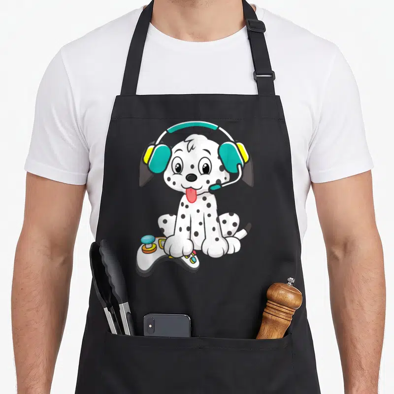 Tablier de cuisine noir avec un Dalmatien mignon équipé d'un casque et d'une manette de jeu vidéo.
