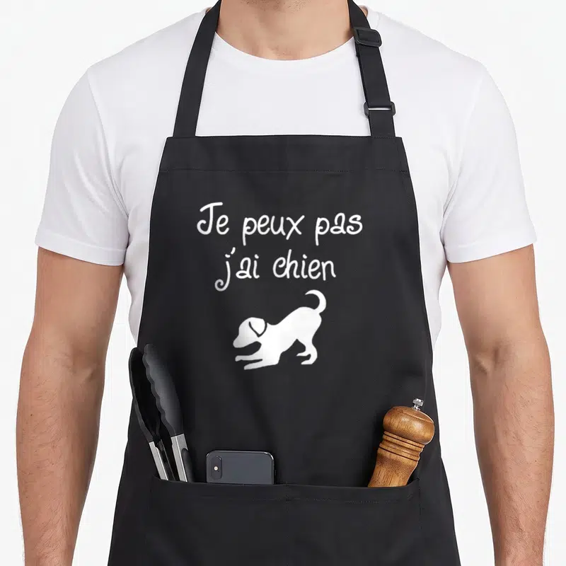 Tablier de cuisine noir avec inscription Je peux pas j'ai chien et silhouette de chien blanc en course.