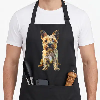 Tablier de cuisine noir avec portrait stylisé d'un chien Cairn Terrier en polygone multicolore.