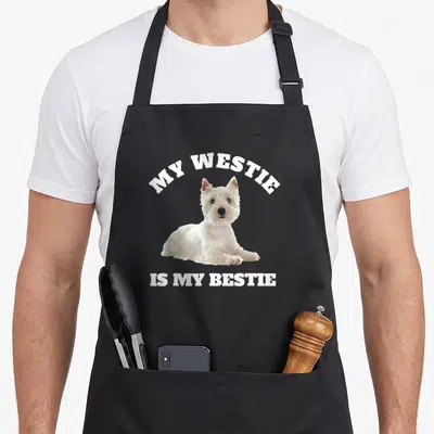 Tablier de cuisine noir avec illustration d'un West Highland Terrier blanc et texte My Westie is My Bestie en lettres capitales blanches.