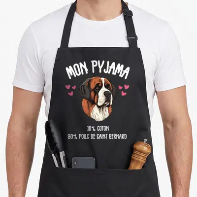 Tablier de cuisine noir avec tête de Saint Bernard et texte humoristique sur fond uni.