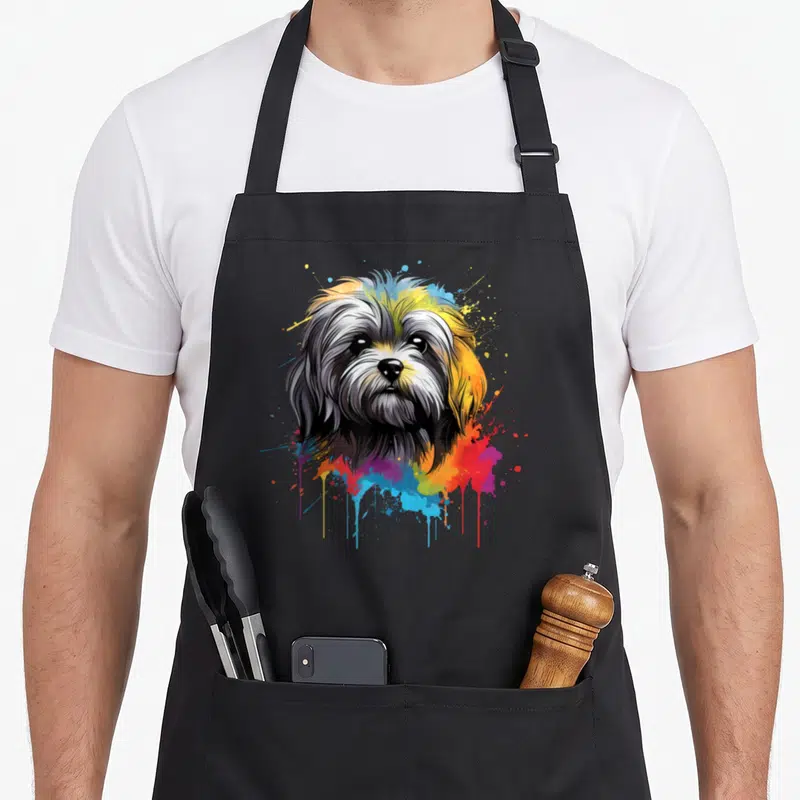 Tablier de cuisine noir avec illustration d'un Lhassa Apso aux couleurs vives et éclats de peinture.