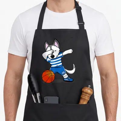 Tablier de cuisine noir avec illustration d'un husky en train de faire le dab près d'un ballon de basket orange.