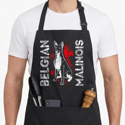 Tablier de cuisine noir avec illustration d'un Belgian Malinois et texte blanc entouré d'éclaboussures rouges.