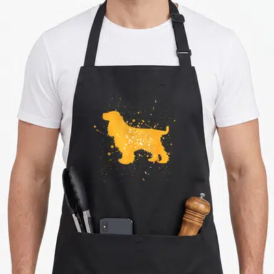 Tablier de cuisine noir avec silhouette orange d'English Cocker Spaniel et éclaboussures blanches.
