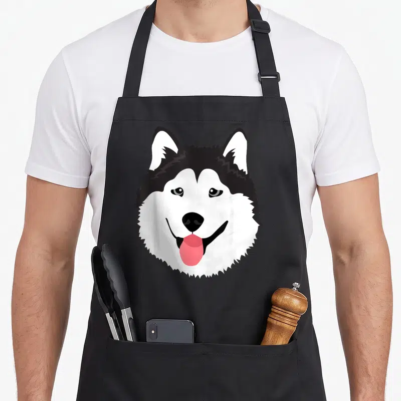 Tablier de cuisine noir avec illustration d'un visage de husky blanc et noir souriant