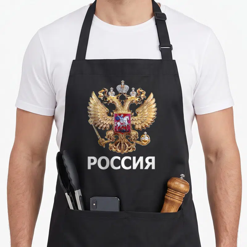Tablier de cuisine noir avec aigle impérial doré et inscription ROSSIA en blanc.