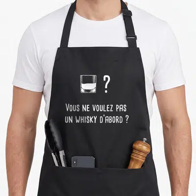 Tablier de cuisine noir avec un verre de whisky dessiné et la phrase Vous ne voulez pas un whisky d'abord en blanc.