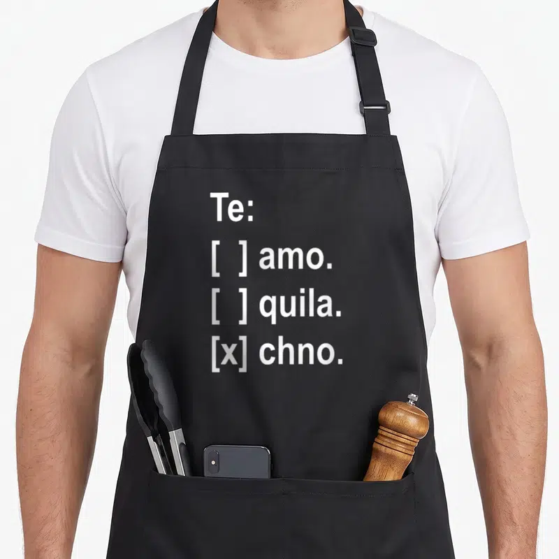 Tablier de cuisine noir avec texte blanc Te amo tequila techno et case à cocher cochée en bas.