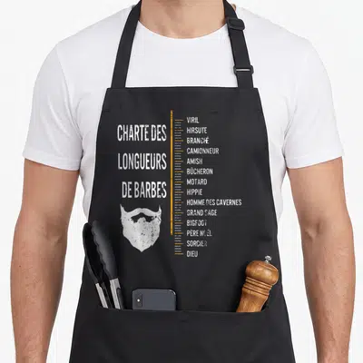 Tablier de cuisine noir avec une charte humoristique des longueurs de barbes et une illustration stylisée de poils du visage.