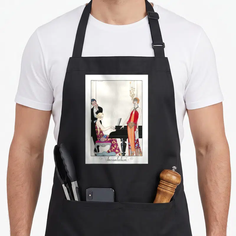 Tablier de cuisine noir avec illustration Art Déco représentant trois personnages autour d'un piano et le mot Incantation en bas.