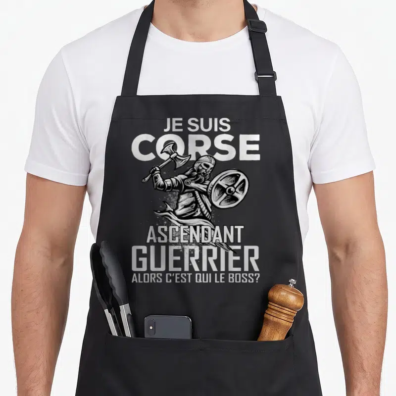 Tablier de cuisine noir avec illustration d'un guerrier barbu brandissant une hache et tenant un bouclier rond en métal.