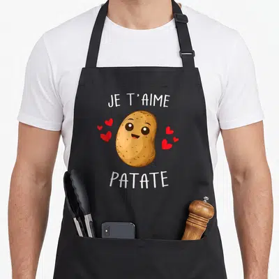 Tablier de cuisine noir avec illustration patate souriante, cœurs rouges et texte Je T'aime Patate en blanc.