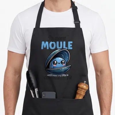 Tablier de cuisine noir avec une moule bleue souriante et le texte La même MOULE pour toute la Vie.