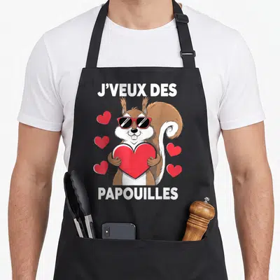 Tablier de cuisine noir avec écureuil portant des lunettes roses et tenant un grand cœur rouge entouré de petits cœurs.