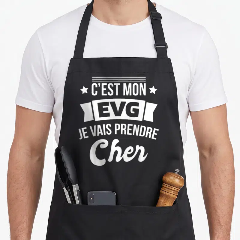 Tablier de cuisine noir avec inscription blanche C'est mon EVG je vais prendre cher et étoiles décoratives.