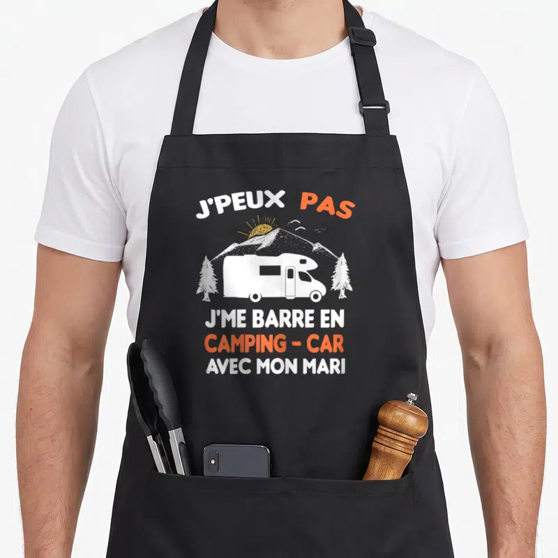 Tablier de cuisine noir avec illustration camping-car, montagnes et texte J'peux pas j'me barre en camping-car avec mon mari