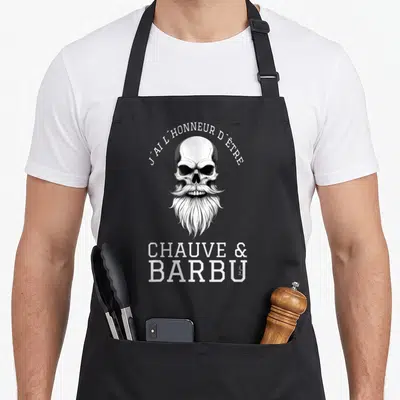 Tablier de cuisine noir avec illustration crâne à longue barbe et texte blanc J'ai l'honneur d'être chauve & barbu.