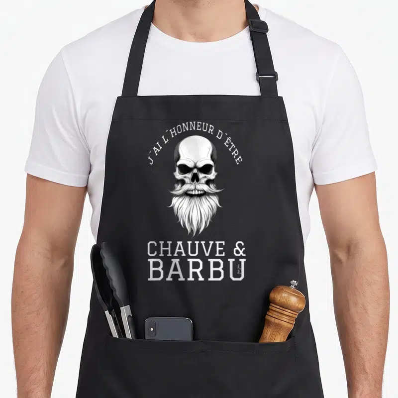 Tablier de cuisine noir avec illustration crâne à longue barbe et texte blanc J'ai l'honneur d'être chauve & barbu.